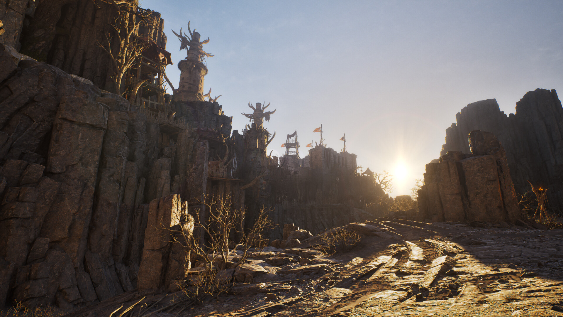 A dusk-lit canyon in Auroria with banners on the cliff and a dirt road running toward the sun